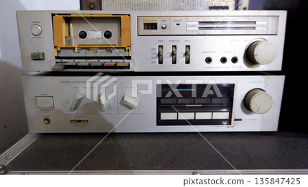 Vintage Stereo Cassette Deck and Integrated Amplifier Stack with Analog Controls Vintage Stereo Cassette Deck and Integrated Amplifier Stack with Analog Controls 135847425