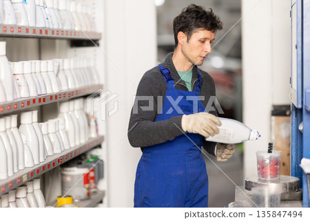 Man auto colorist combines different paint colors 135847494