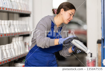 Girl auto colorist combines different paint colors Girl auto colorist combines different paint colors 135847535