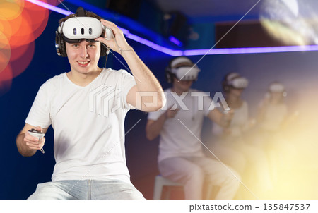 Stunned by exciting game, guy lowered helmet and took break from game. Stunned by exciting game, guy lowered helmet and took break from game. 135847537