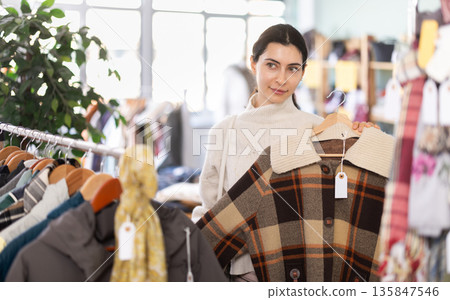 Regular customer Armenian woman chooses color and style of plaid jacket Regular customer Armenian woman chooses color and style of plaid jacket 135847546