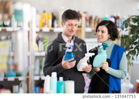 man consults with the seller about the quality of singing products and sprays man consults with the seller about the quality of singing products and sprays 135847753