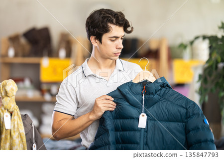 In chain shop, guy choose down jacket In chain shop, guy choose down jacket 135847793