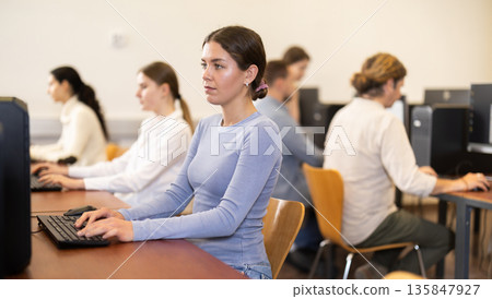 Young woman working on computer in office Young woman working on computer in office 135847927