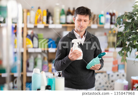 European man chooses a spray European man chooses a spray 135847968