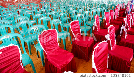 Decorated Red Chairs and Teal Plastic Chairs for Event Seating Decorated Red Chairs and Teal Plastic Chairs for Event Seating 135848101