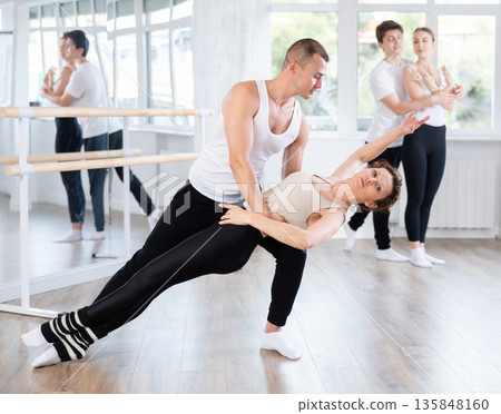 Young man and adult woman rehearsing pair ballet 135848160