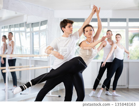 Young guy and adult woman rehearsing pair ballet 135848163