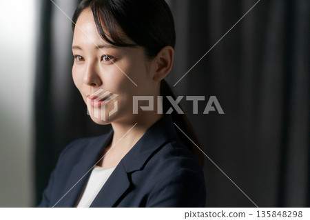 Smiling young woman in a suit Smiling young woman in a suit 135848298