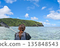 Back view of a woman looking at the beautiful Okinawan sea 135848543