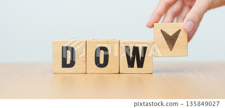 Hand change wooden block of Dow Jones Index text to UP and Down arrow symbol icon. stock market index, trade, trade company in the United States, financial growth and Cut loss concept Hand change wooden block of Dow Jones Index text to UP and Down arrow symbol icon. stock market index, trade, trade company in the United States, financial growth and Cut loss concept 135849027