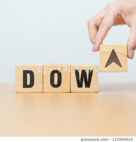 Hand change wooden block of Dow Jones Index text to UP and Down arrow symbol icon. stock market index, trade, trade company in the United States, financial growth and Cut loss concept Hand change wooden block of Dow Jones Index text to UP and Down arrow symbol icon. stock market index, trade, trade company in the United States, financial growth and Cut loss concept 135849028