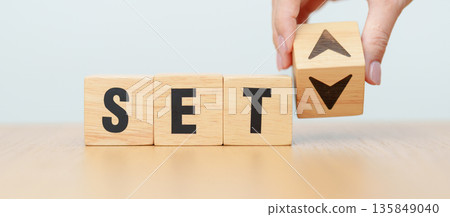 Hand change wooden block with SET text or The Stock Exchange of Thailand to UP and Down arrow symbol icon. decrease and increase, price, stocks, financial, trade, value and Cut loss concept 135849040