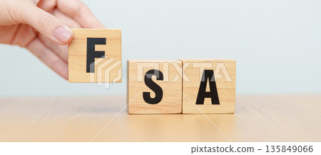 hand change wooden block of FSA. HSA, Flexible Spending Account and Health Savings Account, Medical Expenses, Tax Benefits and healthcare concepts 135849066