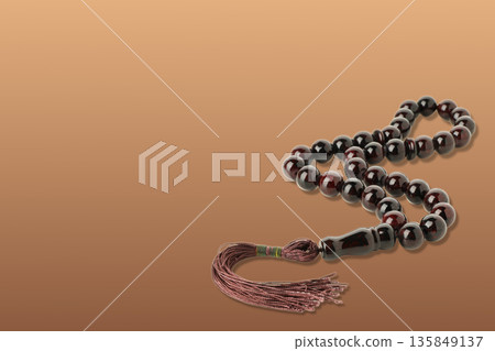 Prayer beads shine against a warm backdrop for Ramadan Prayer beads shine against a warm backdrop for Ramadan 135849137