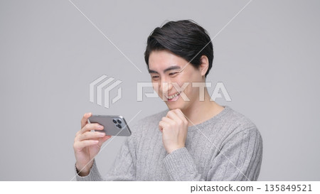 Man watching video on smartphone Man watching video on smartphone 135849521