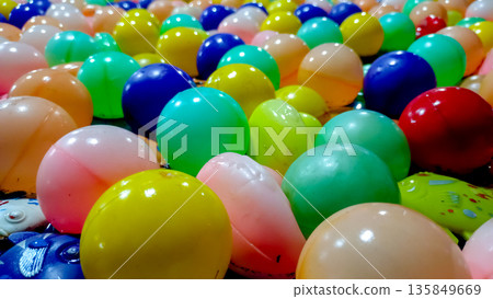 Low Angle Perspective of Colorful Plastic Balls Floating on Water 135849669