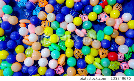 Multi Colored Plastic Balls and Sea Animal Toys Scattered in Water 135849670