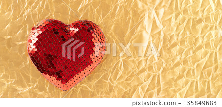 Red sequin heart on golden crumpled paper Red sequin heart on golden crumpled paper 135849683