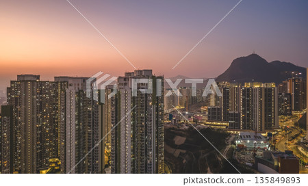 Jan 18 2026 Highrise residential blocks standing beneath Hong Kong Lion Rock 135849893