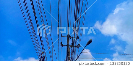 Intricate Network of Electrical Wires and Power Distribution Lines on Utility Pole 135850320