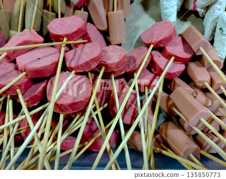 Sliced Red Sausages and Hot Dogs on Bamboo Skewers for Grilling Sliced Red Sausages and Hot Dogs on Bamboo Skewers for Grilling 135850773