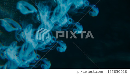 Blur fume explosion. Ink blob. Blue color dye dissolving underwater. Art kaleidoscopic prism drip trickles on abstract dark black background. Blur fume explosion. Ink blob. Blue color dye dissolving underwater. Art kaleidoscopic prism drip trickles on abstract dark black background. 135850918