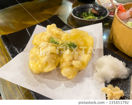 Cod milt tempura served with grated daikon radish. Cod milt tempura served with grated daikon radish. 135851792