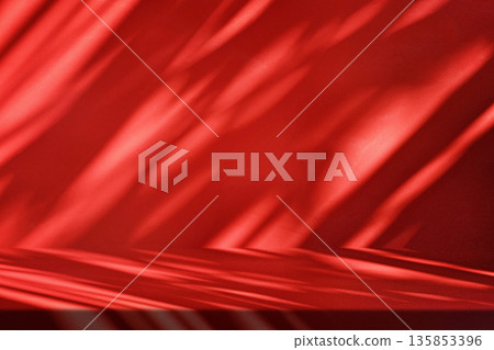 Stucco Table with Red Background with Leaf Shadows 135853396