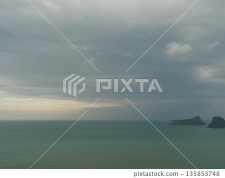Gray Cumulonimbus cloud formations on sky above mountain, Nimbus moving in wetlands, Appearance of rain cloud, Lake while rain falling in Thailand 135853748