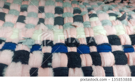 Close Up of Handwoven Cotton Floor Mat with Pink Grey and Black Checkerboard Pattern 135853888