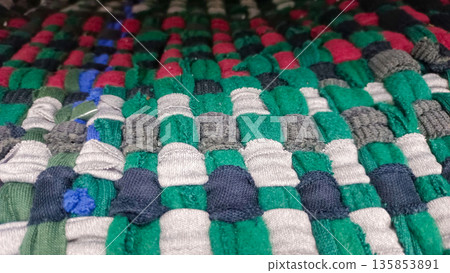 Colorful Fabric Rag Rug Texture with Green Red and White Woven Patterns Colorful Fabric Rag Rug Texture with Green Red and White Woven Patterns 135853891