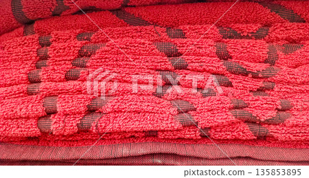 Detailed Texture of a Red Microfiber Towel with Embossed Pattern Detailed Texture of a Red Microfiber Towel with Embossed Pattern 135853895