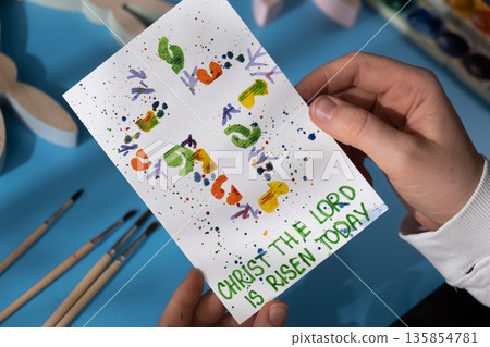 EASTER cross painting with message CHRIST THE LORD IS RISEN TODAY Sustainable preparation Diy process of making handmade greeting cards. Step by step activity for children. Inclusive and responsible 135854781