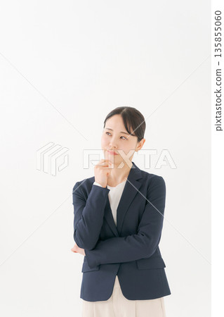 A businesswoman with a worried expression 135855060