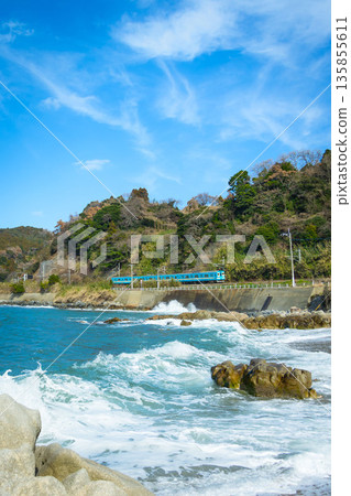 A blue train running along the Itoshima coastline 135855611