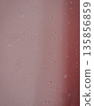 Close-up of water droplets on a pink wall 135856859