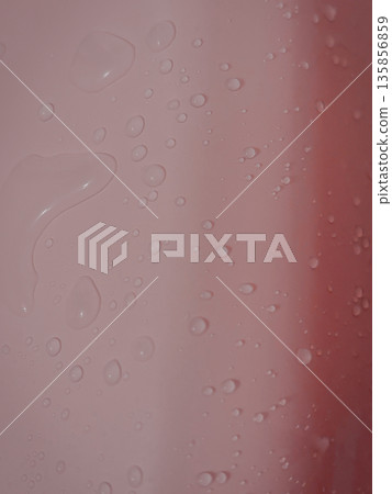 Close-up of water droplets on a pink wall 135856859