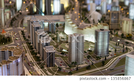 A detailed model of a modern building complex is displayed in a city district. This representation shows future developments and planned structures for real estate in the area. 135856867