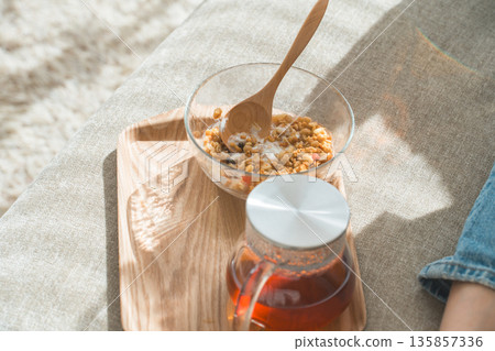 Granola and tea on a tray, breakfast, tea time Granola and tea on a tray, breakfast, tea time 135857336
