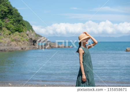 A woman walking along the beach A woman walking along the beach 135858671
