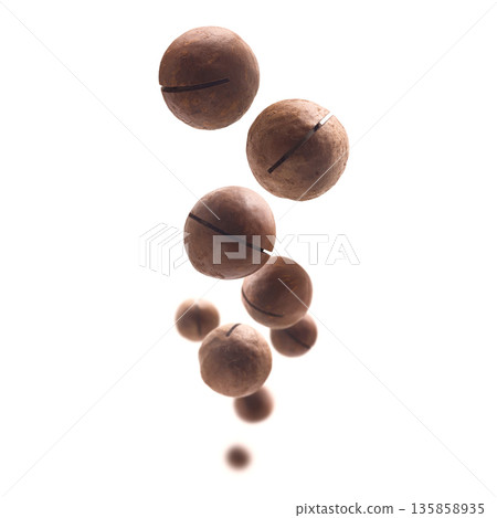 Unpeeled macadamia nuts levitate on a white background 135858935