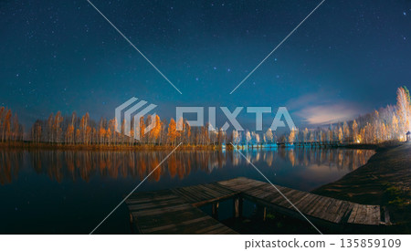Autumn Night Lake with Starry Sky and Wooden Pier Autumn Night Lake with Starry Sky and Wooden Pier 135859109