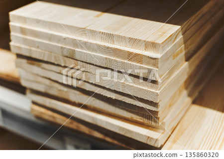 Stack Of Freshly Cut Pine Planks With Visible Grain, Representing Building Materials 135860320