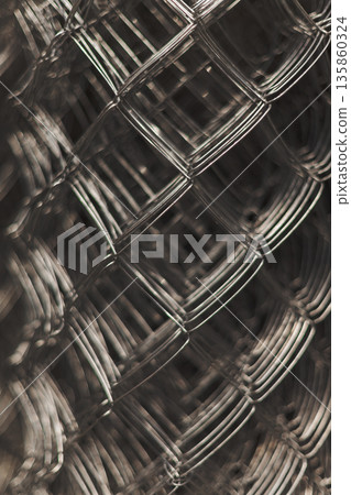 Abstract Close-Up Of Interwoven Metal Wire Mesh, Highlighting Industrial Texture 135860324