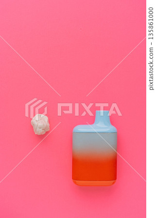 Disposable vape device with gum piece on pink background, minimal concept Disposable vape device with gum piece on pink background, minimal concept 135861000