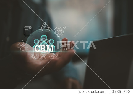 Customer Relationship Management Concept with Digital Icons and Hand Holding CRM Visualization 135861700