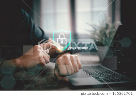 Person using smartwatch with data protection concept and laptop in office 135861701