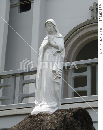A statue of Mary standing in front of the Catholic Himosashi Church, one of the most Romanesque churches in the East, in Himosashi-cho, Hirado City, Nagasaki Prefecture A statue of Mary standing in front of the Catholic Himosashi Church, one of the most Romanesque churches in the East, in Himosashi-cho, Hirado City, Nagasaki Prefecture 135862329