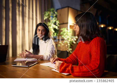 Modern office meeting with team discussing project solutions. Modern office meeting with team discussing project solutions. 135862405